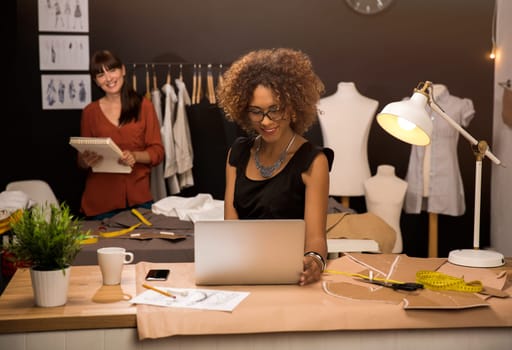 Two young entrepreneur women, and fashion designer working on her atelier