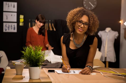 Two young entrepreneur women, and fashion designer working on her atelier