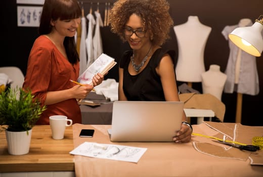Two young entrepreneur women, and fashion designer working on her atelier