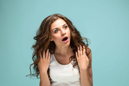The portrait of Fright young woman with shocked facial expression