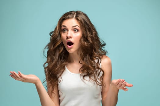 The portrait of young woman with shocked facial expression