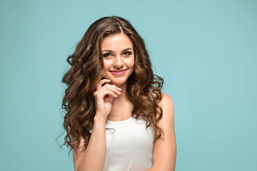 The young woman's portrait with happy emotions on gray background