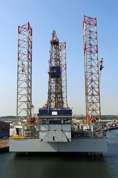 An oil platform in a port by the sea. An oil rig in the sea