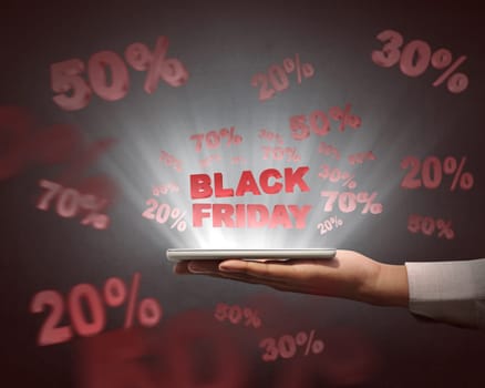 People holding tablet and showing special sale on Black Friday over black background