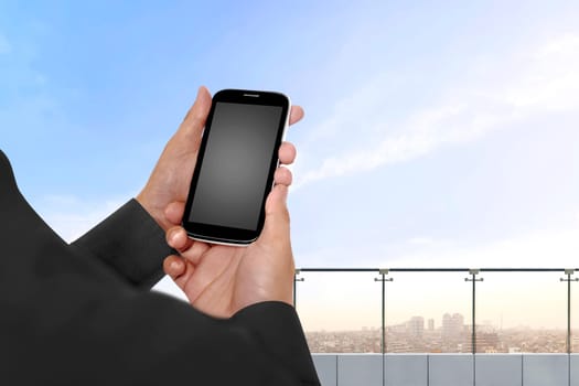 Hand holding cellphone with empty blank screen for copyspace