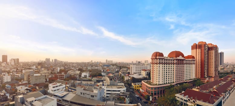 Portrait of jakarta cityscape with modern building against dramatic sky background