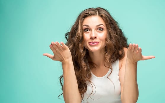 The portrait of alarmed young woman with shocked facial expression