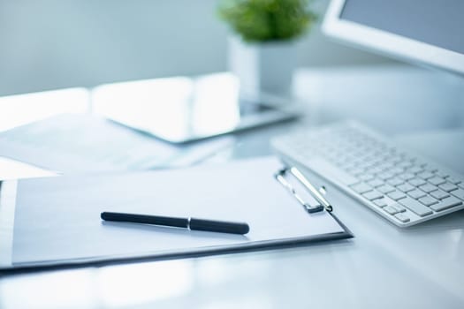 The tipical office desktop with pc, pens, notebook, laptop