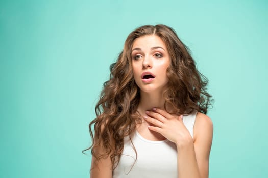 The portrait of alarmed young woman with shocked facial expression