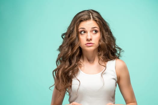 The portrait of alarmed young woman with shocked facial expression
