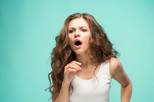 The portrait of alarmed young woman with shocked facial expression
