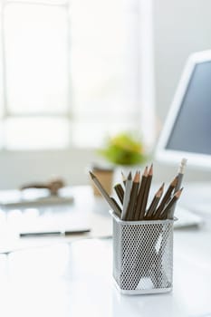 The tipical office desktop with pc, pens, notebook, laptop