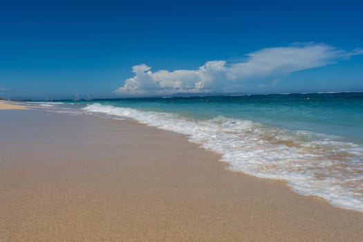 Beautiful secluded sandy beach in the Caribbean with white sand and blue sky as in paradise