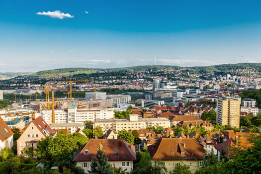 Picturesque view of Stuttgart Germany the modern skyscrapers under the traditional historical architecture overlooking the surrounding hills on a sunny day
