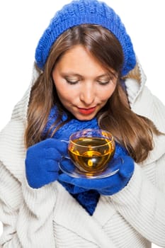 Young woman with dark hair and blue wool lyant drink a cup of tea to be isolated on white background