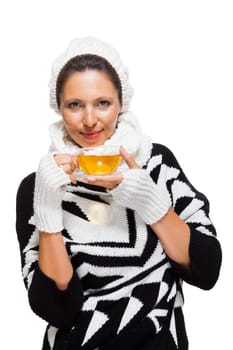Young brunette woman with white wool lyane drinks a cup of tea to warm up isolated on white background