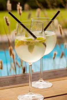 Fresh Hugo with mint lime and sparkling wine in a wine-weinin in summer by the water