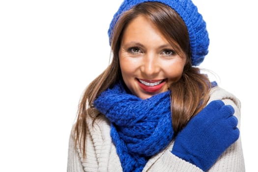attractive pretty young woman with blue wool hat with long dark hair in winter isolated on white background