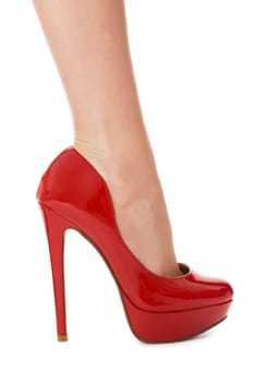 attractive female legs with red stilettos high heels as close-up isolated on white background