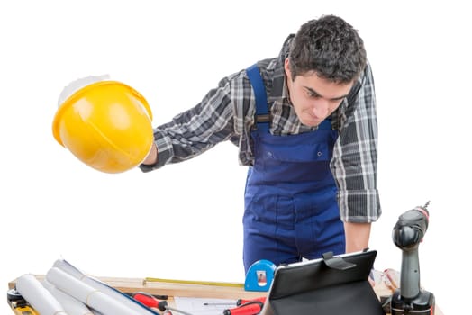a young worker is angry and throws his helmet