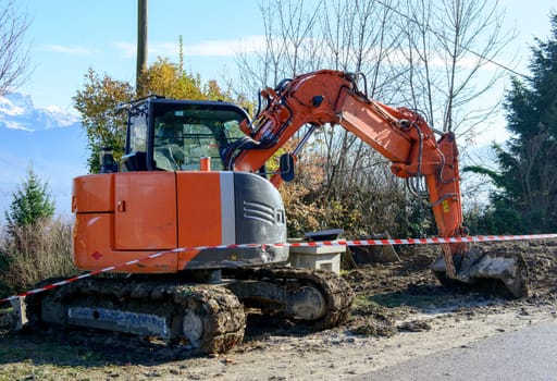 excavator is working on the side of the road