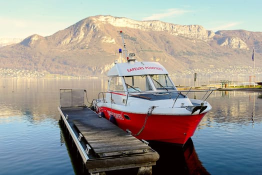 Firefighter boat moored at the dock on Lake Annecy