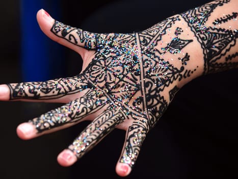 image showing isolated hand of an Indian bride with herbal heena.