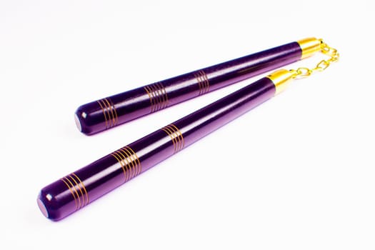 Purple nunchaku, the asian weapon isolated on white background.