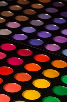 Eye shadow palette with beautiful different colors on black background.