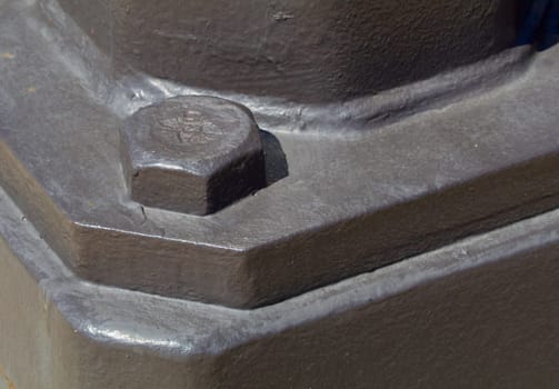 Large painted bolt head showing holding piece in place