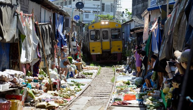 The Maeklong Railway Market at Maeklong Station south-west of Bangkok in Thailand in South East Asia.