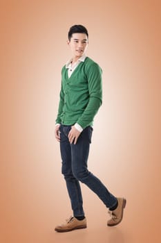 Attractive young Asian man, full length portrait isolated on white background.