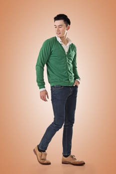 Handsome young Asian man with sweater, full length portrait isolated.