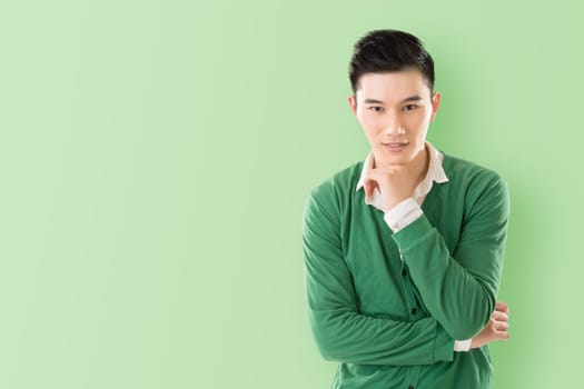 Sensitive Asian young man, closeup portrait with colorful background.