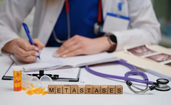 A dedicated doctor carefully writing detailed notes on metastases with various medical tools and prescriptions nearby