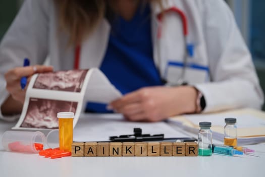 A medical professional reviews a patient report, focusing on the prescribed painkiller for effective management