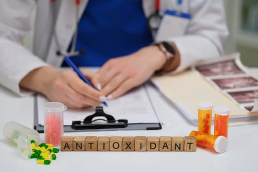 A healthcare professional documents findings on antioxidant supplements and medications used for treatments