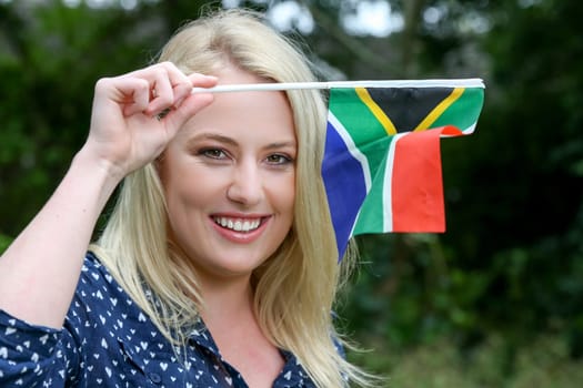 Pretty young lady waving the South African flag