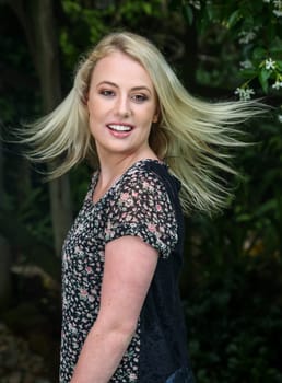 Gorgeous young blond lady with hair splayed and smiling