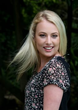 Gorgeous young blond lady with hair splayed and smiling
