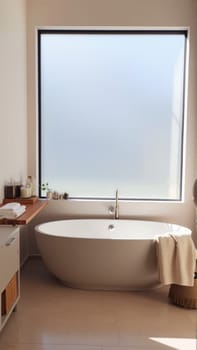 Scandinavian style bathroom interior in light colors. The bathtub is located near the window. High quality photo