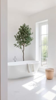 Scandinavian style bathroom interior in light colors. The bathtub is located near the window. High quality photo