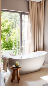 Scandinavian style bathroom interior in light colors. The bathtub is located near the window. High quality photo