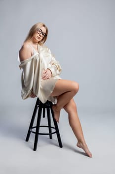 A captivating portrait showcasing a woman dressed in a soft outfit, beautifully exuding elegance and confidence