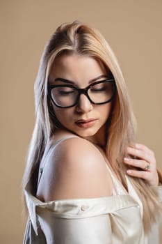 A beautiful young woman poses confidently, showcasing modern fashion and elegance in this striking portrait.