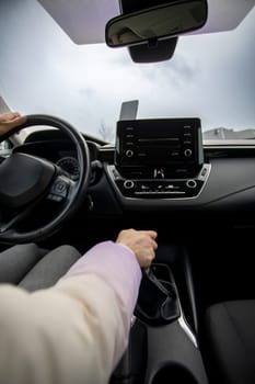 A drivers perspective showcases a modern car interior, complete with a sleek and advanced infotainment system