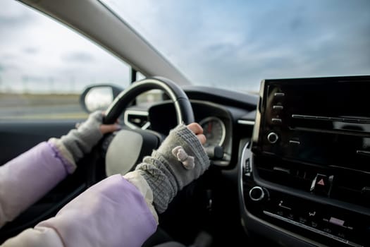A detailed closeup of hands firmly gripping the steering wheel, showcasing the exhilaration of driving a car