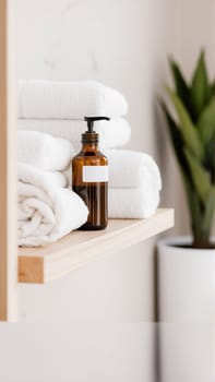 Spa treatment set, wooden shelf with neatly folded towels and dispensers for soap, cream, massage oil. High quality photo