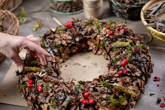 A beautifully crafted wreath with leaves, vibrant berries, and natural materials for delightful seasonal decor