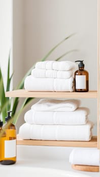 Spa treatment set, wooden shelf with neatly folded towels and dispensers for soap, cream, massage oil. High quality photo